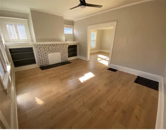 1127 Metropolitan Pkwy SW, Atlanta, GA 30310 - unfurnished living room featuring crown molding, baseboards, a ceiling fan, wood finished floors, and a brick fireplace