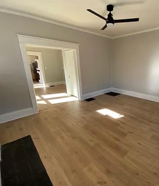 1127 Metropolitan Pkwy SW, Atlanta, GA 30310 - spare room featuring crown molding, light wood-type flooring, ceiling fan, and baseboards