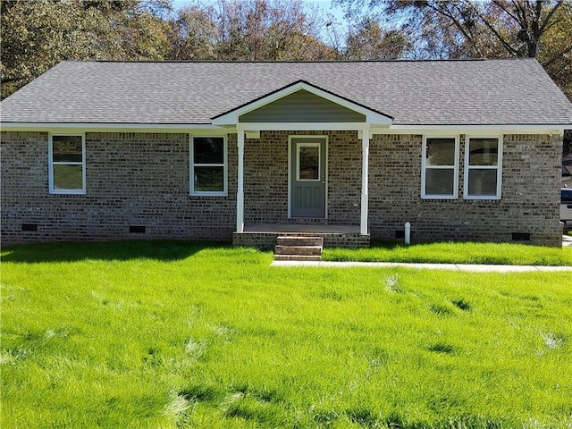 ranch-style house featuring covered porch and a front lawn