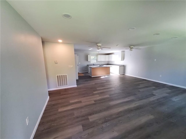 unfurnished living room featuring dark hardwood / wood-style flooring