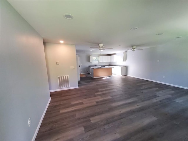 unfurnished living room featuring dark hardwood / wood-style flooring and sink