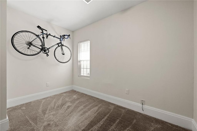 carpeted spare room with baseboards