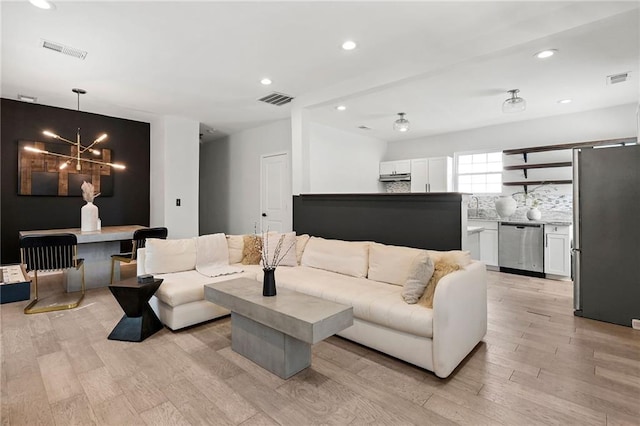 living room featuring recessed lighting, visible vents, and light wood finished floors