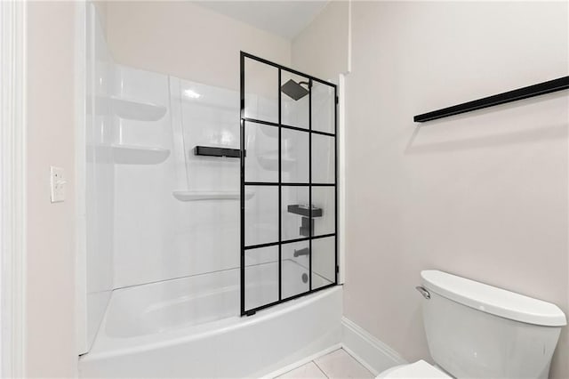 bathroom featuring baseboards, toilet, bath / shower combo with glass door, and tile patterned flooring