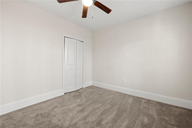 unfurnished bedroom featuring a closet, ceiling fan, baseboards, and carpet