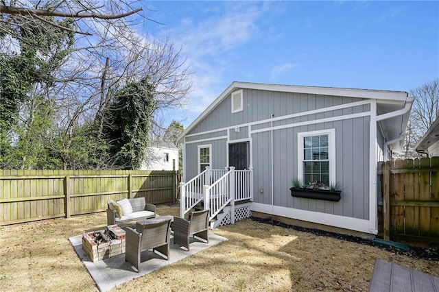 view of outdoor structure featuring outdoor lounge area and a fenced backyard