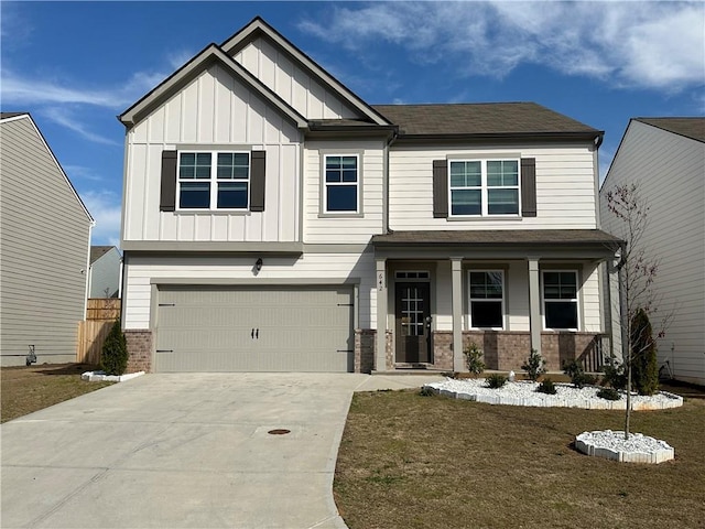 craftsman inspired home with a porch, a garage, and a front lawn