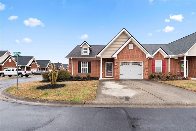 view of front facade with a garage, a front lawn, brick siding, and driveway