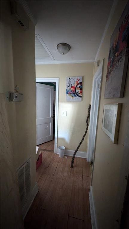 corridor featuring crown molding and hardwood / wood-style flooring