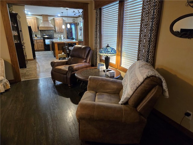 living area with light wood-style floors, plenty of natural light, and baseboards