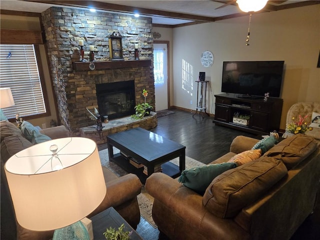 living room featuring beam ceiling, a fireplace, baseboards, and wood finished floors