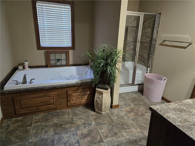 bathroom with a stall shower and a bath