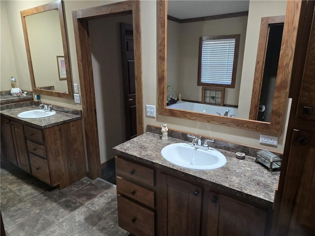 bathroom featuring crown molding, two vanities, and a sink