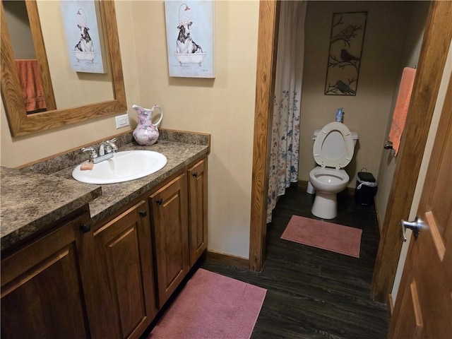 full bathroom featuring vanity, toilet, and wood finished floors