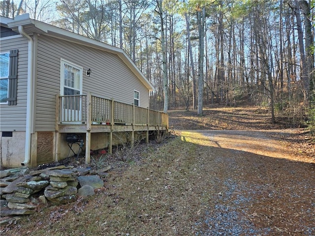 view of side of home featuring a wooden deck