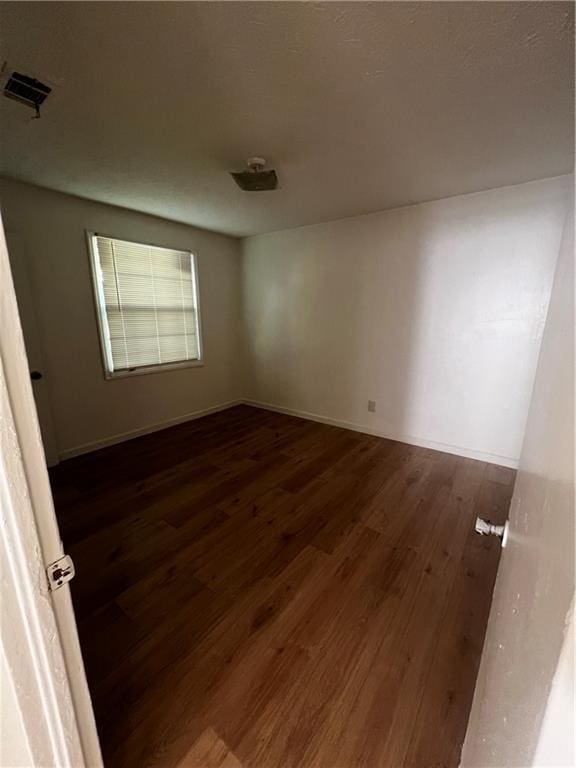 empty room with dark hardwood / wood-style floors