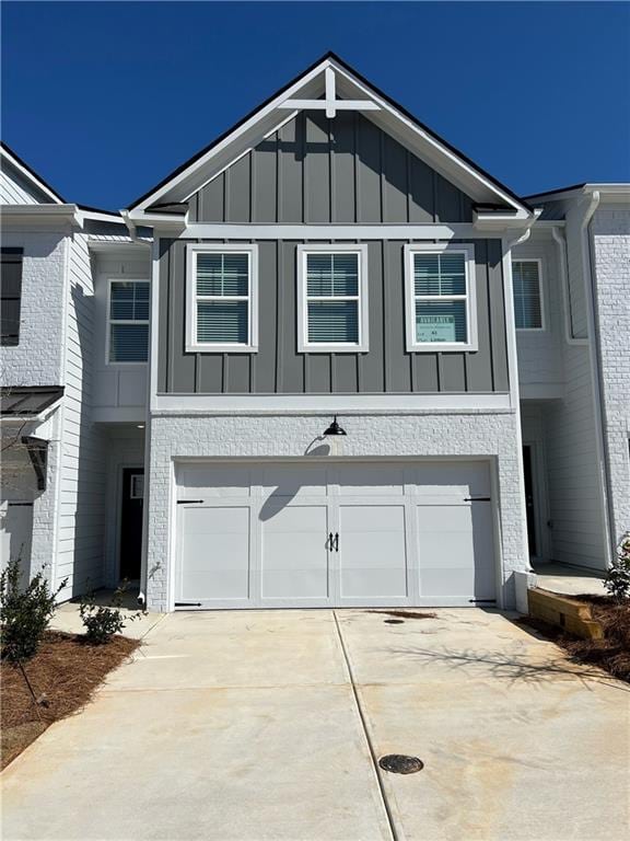 view of front of property featuring a garage, concrete driveway, and board and batten siding