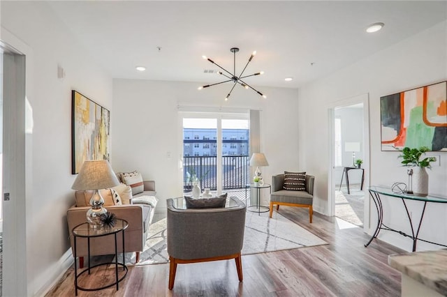 living room with hardwood / wood-style floors and a chandelier