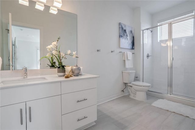 bathroom with vanity, toilet, and an enclosed shower