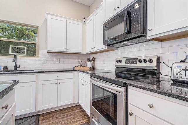 1549 Miller Valley Dr, Bethlehem, GA 30620 - kitchen with electric range, black microwave, a sink, white cabinetry, and dark stone counters