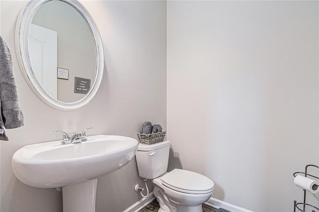 1549 Miller Valley Dr, Bethlehem, GA 30620 - bathroom featuring toilet, baseboards, and a sink