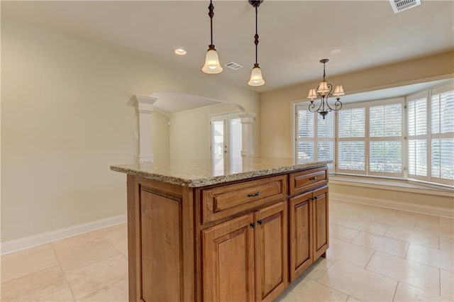 kitchen with visible vents, brown cabinetry, baseboards, french doors, and arched walkways