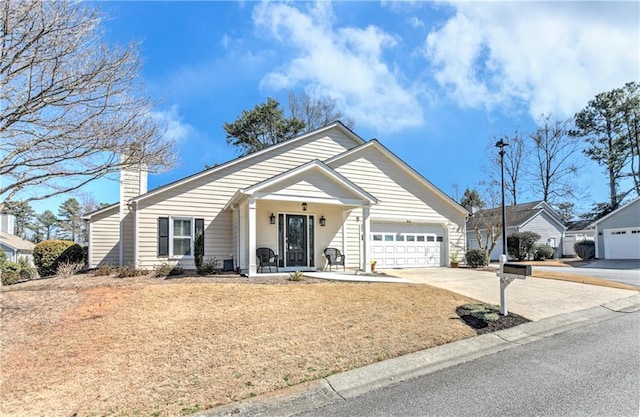 view of front of property featuring a front lawn, a porch, concrete driveway, a garage, and a chimney