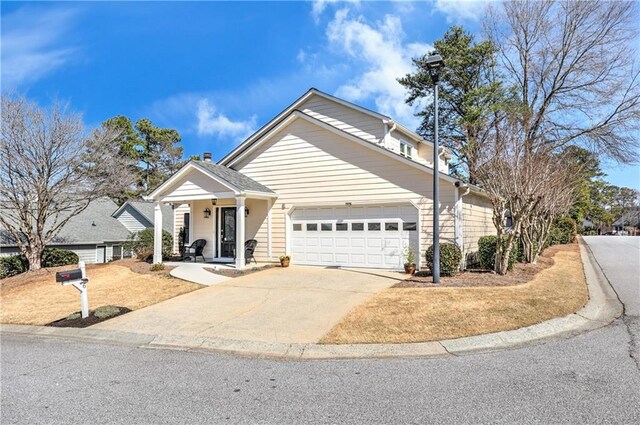 traditional-style house with a garage and concrete driveway