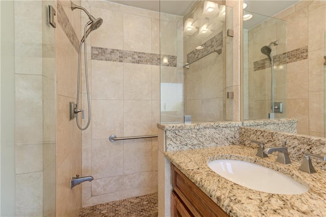 bathroom featuring vanity and a shower stall