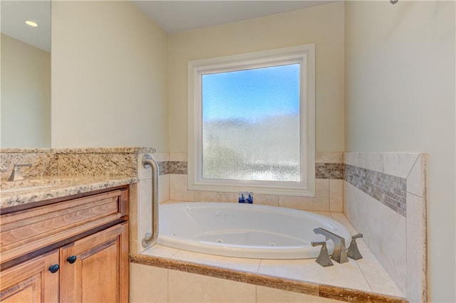 bathroom featuring vanity and a tub with jets