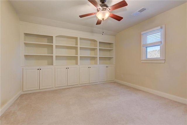 empty room featuring a ceiling fan, baseboards, visible vents, and light carpet