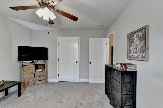 interior space with a textured ceiling and ceiling fan