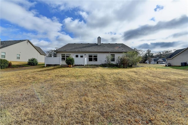 rear view of house with a yard