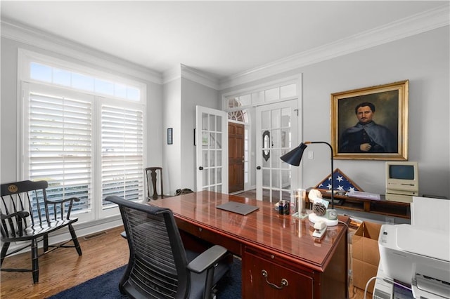 home office with visible vents, wood finished floors, crown molding, and french doors