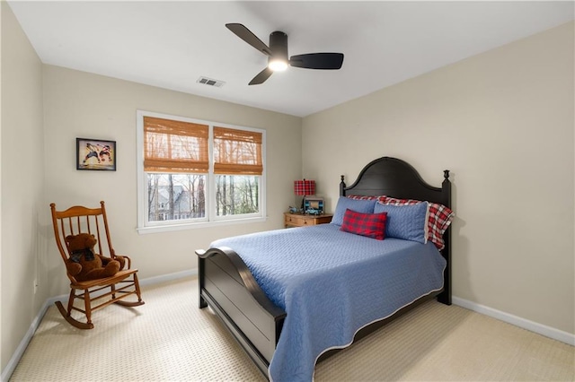 bedroom featuring light carpet, ceiling fan, visible vents, and baseboards