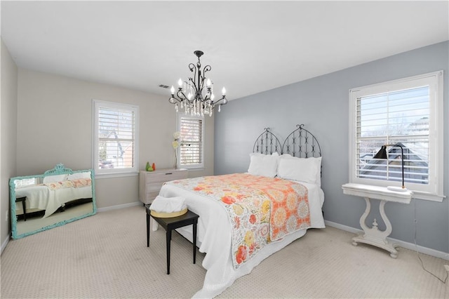 carpeted bedroom featuring visible vents, baseboards, and a notable chandelier