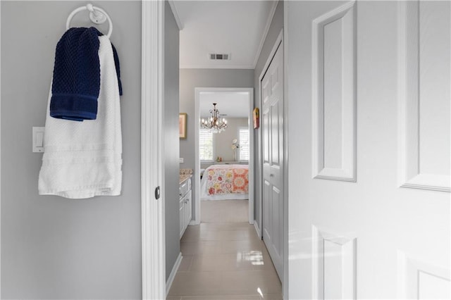 corridor featuring ornamental molding and visible vents