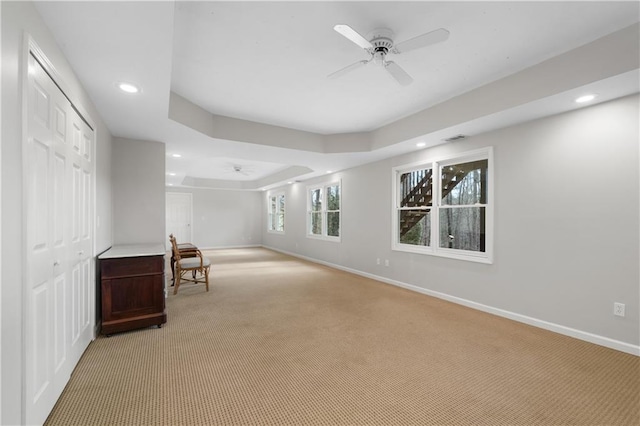 interior space featuring light carpet, ceiling fan, baseboards, and recessed lighting