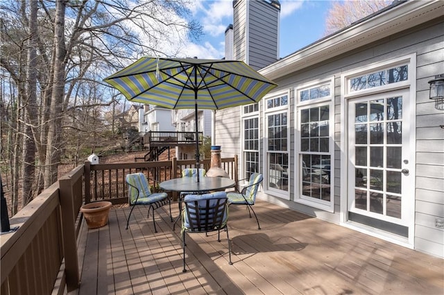 wooden terrace featuring outdoor dining space