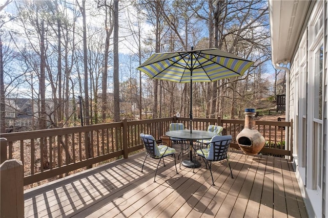 wooden terrace with outdoor dining area