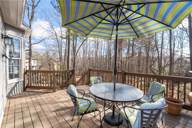 wooden terrace featuring outdoor dining space