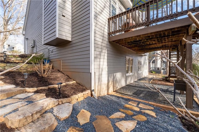 view of home's exterior with stairs and a patio