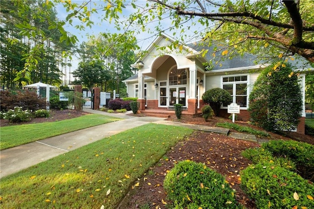 view of front of property featuring brick siding and a front lawn