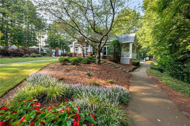 view of front of property with covered porch and a front yard