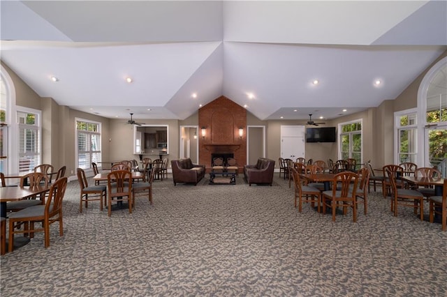 dining room featuring a large fireplace, a ceiling fan, lofted ceiling, carpet floors, and recessed lighting