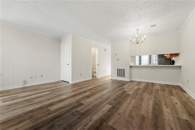 unfurnished living room with a notable chandelier, visible vents, ornamental molding, a textured ceiling, and wood finished floors