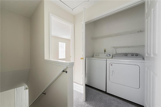 laundry room with attic access, washing machine and dryer, laundry area, and carpet floors