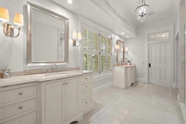 bathroom featuring crown molding, tile patterned floors, and vanity