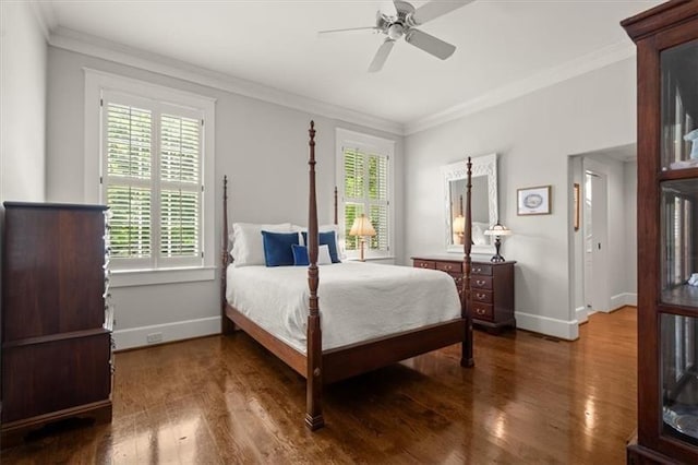 bedroom featuring ceiling fan, multiple windows, dark hardwood / wood-style flooring, and crown molding