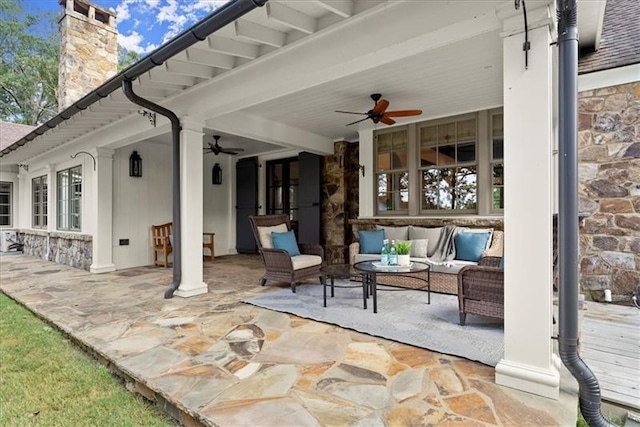 view of patio with ceiling fan and an outdoor living space